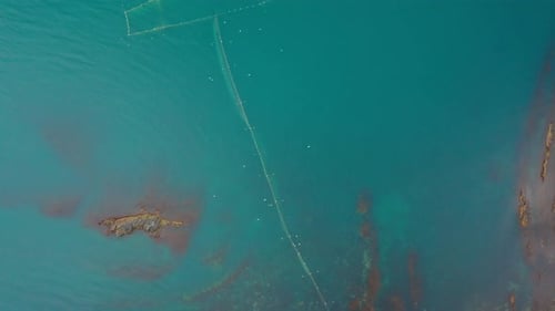 Drone flight above fishing nets in the sea water