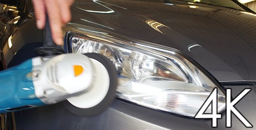 Car Headlight Being Polished with a Power Buffer
