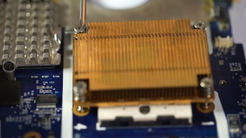 Technician Repairs Computer by Removing Heat Sink