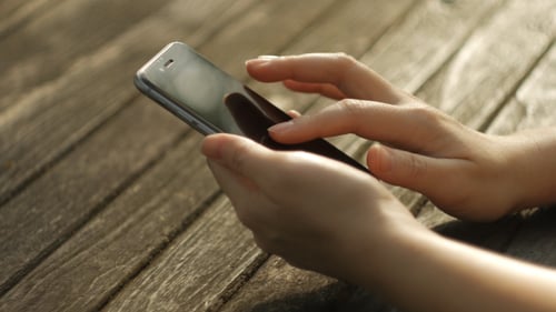 Mobile Phone in Hands Close Up