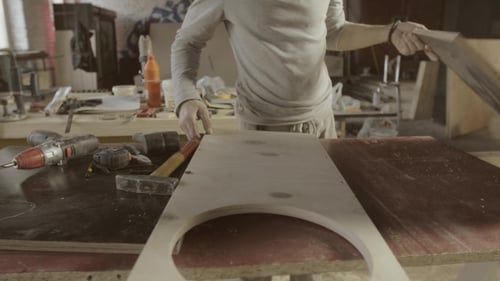 Man Working on Woodworking Project in Workshop