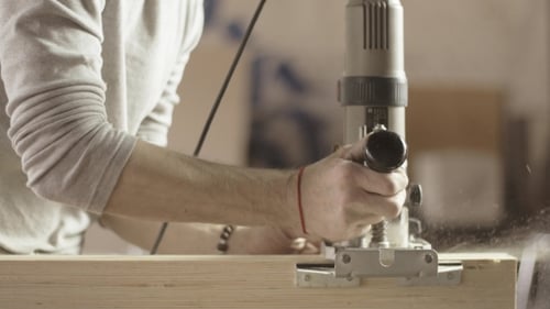 Man Using Woodworking Machine in Workshop