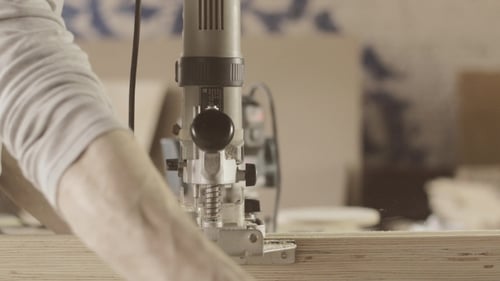 Woodworker Using a Vertical Milling Machine on Wood