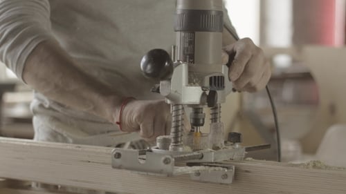 Adult Using Wood Router for Carpentry