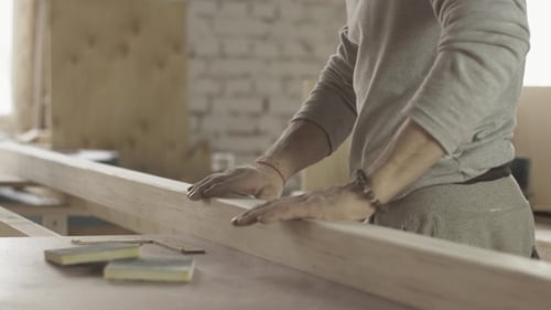 Woodworker Examining Lumber in Studio