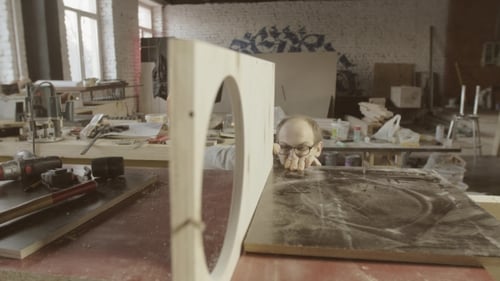 Caucasian Adult Crafts Wooden Board in Workshop