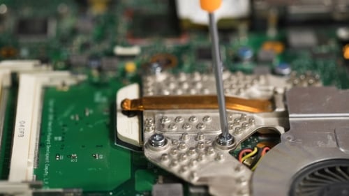 Screwdriver Tightening Screws on Computer Components