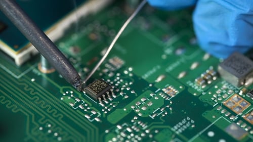 Elektronisch Laborarbeitsplatz mit Lötkolben und Leiterplatte
