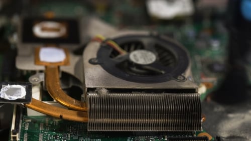 Cleaning Dusty Laptop Fan with Brush and Pen