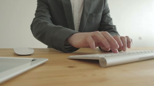Businessman With Keyboard And Laptop In Office. Front View. Concept Of Work.