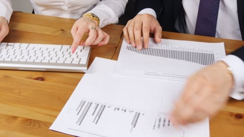Woman And Man Working In An Office Typing On The Keyboard