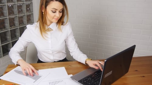The Girl Working At The Computer In The Office