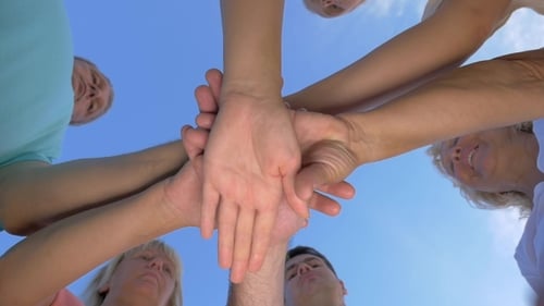 Teamwork and Unity Expressed with Hands Reaching Up