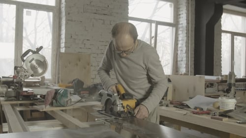 Man Using Circular Saw in Bright Workshop