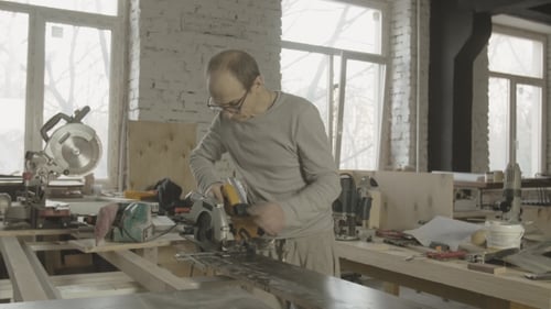 Craftsman Cutting Material in Workshop