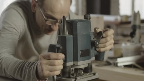 Man Uses Milling Machine in Workshop