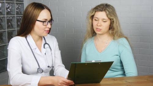 Female Doctor Consulting with Patient at the Hospital