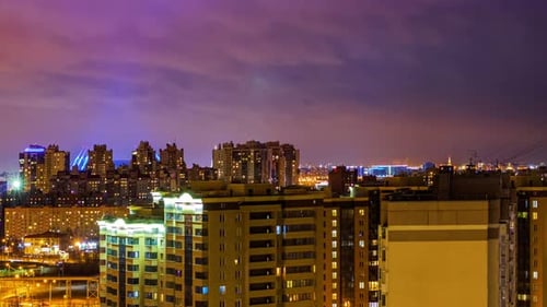 Night cityscape, Timelapse. Lights of buildings on the skyline. Cars lights on the streets