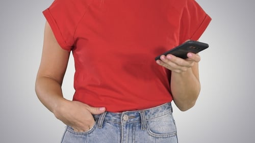 Beautiful woman's hands holding using smart phone on gradient