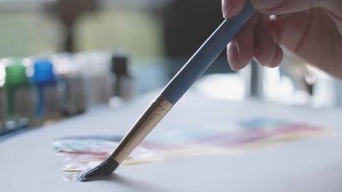 Hand painting colorful water colors on paper close up