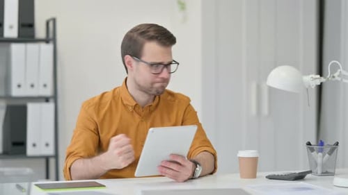 Man in Office Frustrated Using Tablet Computer