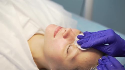 Woman Receiving a Facial Treatment at Spa