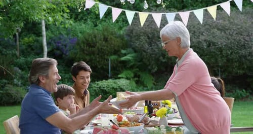 Multi-Generational Family Celebrating Outdoors in Summer Garden