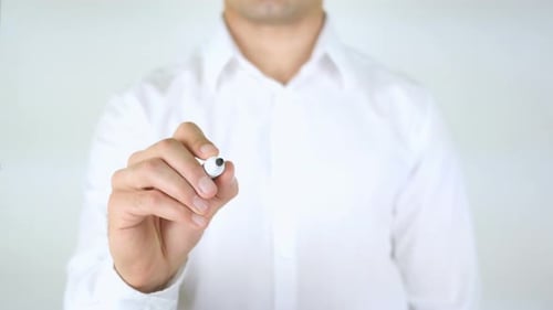 Man Writing Word Good with Marker on Clear Surface