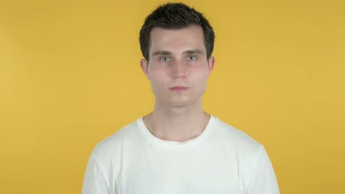 Young Adult Gesturing No on Yellow Backdrop