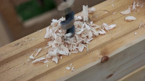 Drill Boring a Hole into Wood Plank