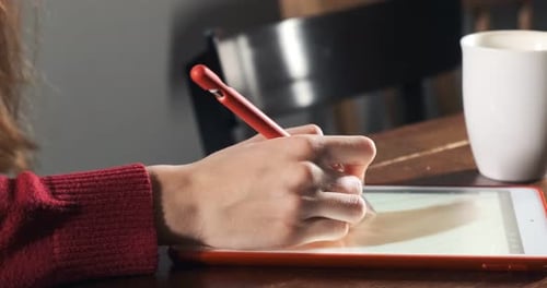 Close Up Female Designer Sitting and Working at Desk. Contemporary Young Woman Drawing and Using Pen