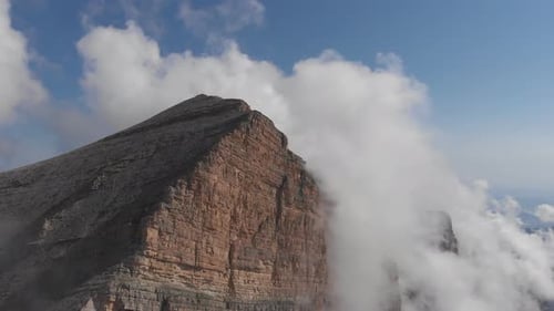 Aerial Shot of Flying Over the Mountain Peaks Among the Clouds.