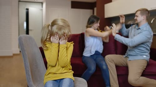 Sad Child Witnessing Parents' Dispute in Living Room