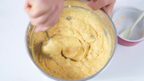 Yellow Baking Batter Being Mixed in Silver Bowl