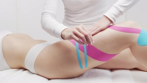Medical Tape Applied to Woman's Leg for Therapy