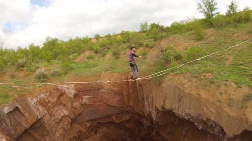 Man Walks Slackline Across Massive Hole
