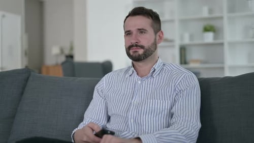 Man Watching TV and Smiling