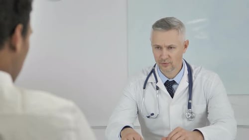 Doctor Giving Medical Advice to Patient in Office