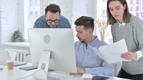 Three People Collaborate in Bright Modern Office