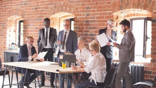 Diverse Business Team Meeting in a Brick Walled Office