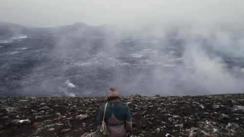 Traveler Exploring Rugged Volcanic Wilderness in Iceland