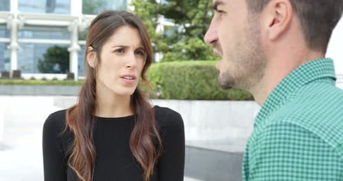 Woman and Man Talking in Urban Setting