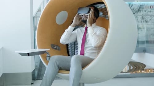Professional Man Using VR Headset in Futuristic Chair