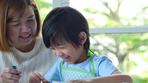 Happy Woman and Child Painting Together