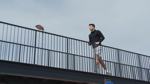 Man running on a stadium walkway