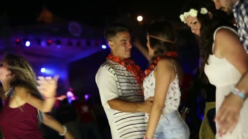 Young Adults Dancing at Outdoor Party at Night