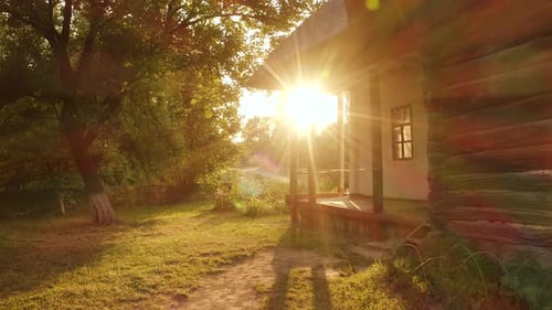 Landscape of Old Hut House Garden and Bright Sunshine Rays