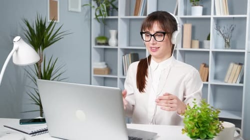 Woman on Video Call in Bright Home Office