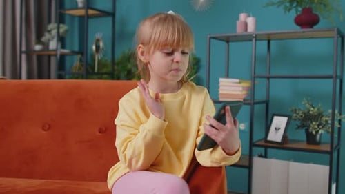 Girl Using Smartphone Sitting on Couch