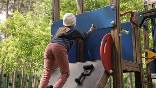 SLOW MOTION Stylish Girl Play on the Playground in the Park